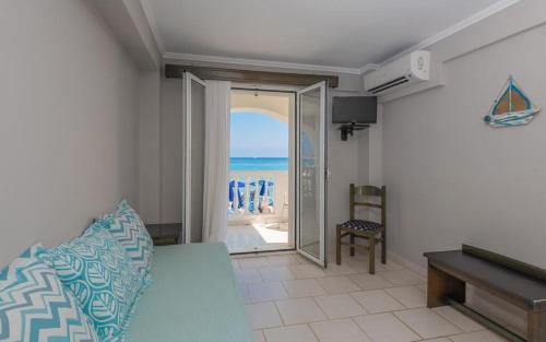a room with a bed and a view of the ocean at Boletsos Beach in Argasi