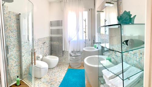 a bathroom with two sinks and two toilets at Heron apartments in Lido di Jesolo