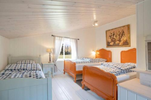 una camera con due letti e una finestra di Eika Cottage: Cozy, rural, spacious and well-equiped a Åmot