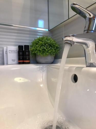 a bathroom sink with water running from a faucet at House Pierro in Orasac