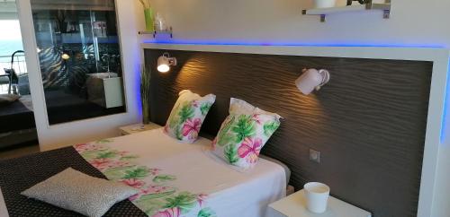 a bedroom with a bed with flowers on it at So Chic in Saint-François