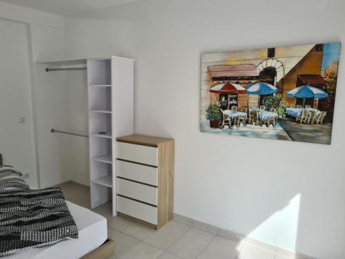 a bedroom with a painting hanging on the wall at Fafa Home with Pool in Essen