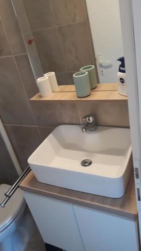 a bathroom with a white sink and a toilet at Maestral in Orebić