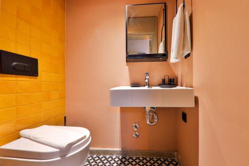 a bathroom with a sink and a toilet at Luff Boutique Hotel - Adult Only in Kas