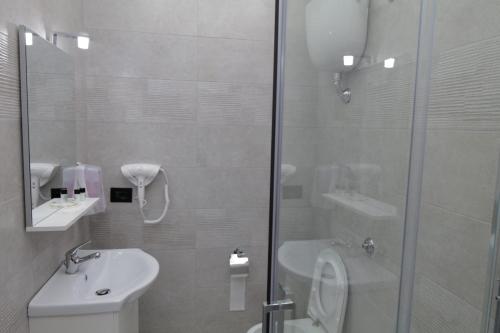 a bathroom with a shower and a toilet and a sink at Albergo 3 Torri in Maddaloni