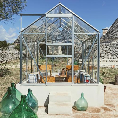 a glass house with vases in front of it at Masseria LoJazzo in Ceglie Messapica