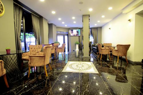 a dining room with chairs and a table in a room at Güler Palas Hotel in Istanbul