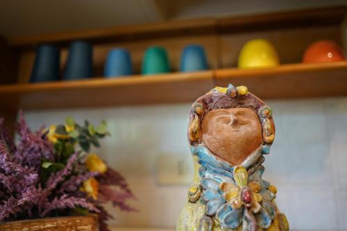 a figurine sitting on a table next to some eggs at B&B PRINCESS ROOM in Capo dʼOrlando