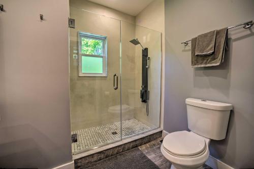 a bathroom with a toilet and a glass shower at Charming Cottage with Deck Mtn and Lake Views! in Wallkill