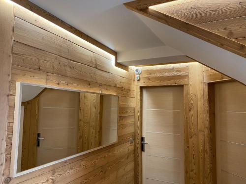 a bathroom with wooden walls and two closets at Sottosopra in Aosta