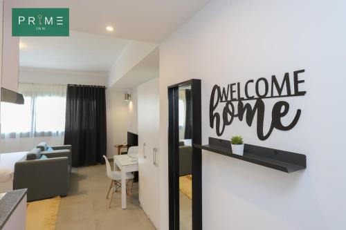 a hotel room with a welcome home sign on the wall at Prime Inn 10th Of Ramadan in Madinat Al Ashir min Ramadan