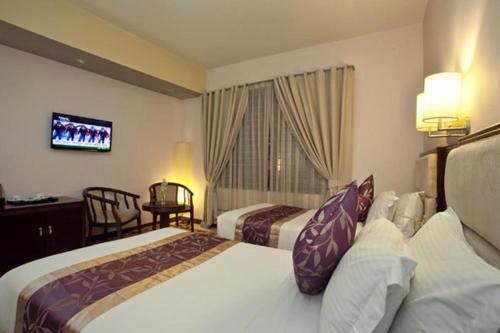 Ένα ή περισσότερα κρεβάτια σε δωμάτιο στο Hotel Star Pacific