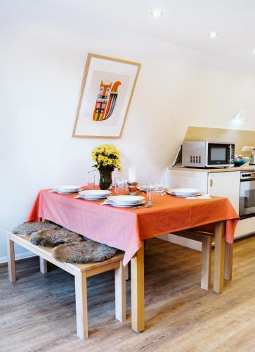 a dining room table with a orange table cloth on it at Nurdachhaus Marie im Nordschwarzwald in Neuhausen