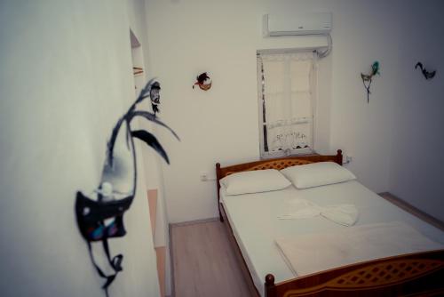 a small bedroom with a bed and a window at The Fir Gate in Gjirokastër