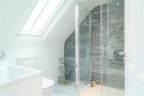 a bathroom with a shower with a toilet at 20 Montpellier - By Luxury Apartments in Cheltenham