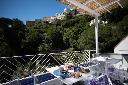 a table and chairs on a balcony with a view at Positamy in Positano