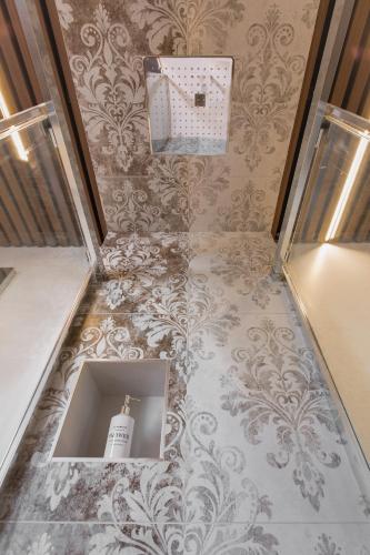 a hallway with a room with a wall with wallpaper at Enjoy Duomo - Flavio Baracchini 9 - Rooms in Milan