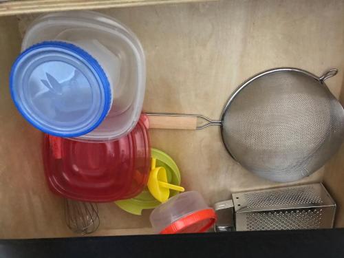 a red jar with a blue lid next to a strainer at DOLPHIN Maeva Residencial in Puerto Peñasco