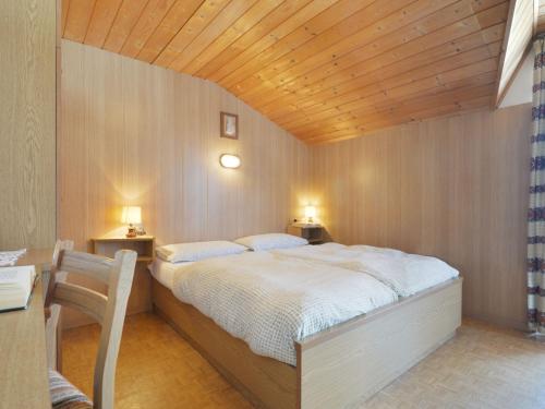 a bedroom with a bed and a wooden ceiling at Apartment Tieja de Gotart-4 by Interhome in Vigo di Fassa