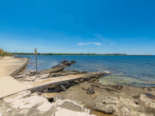 a pier on the shore of a body of water at Apartment Penthouse Mira by Interhome in Umag