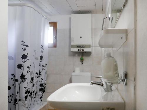 a white bathroom with a sink and a bottle of soap at Holiday Home Rustico Dolomia by Interhome in Acquacalda