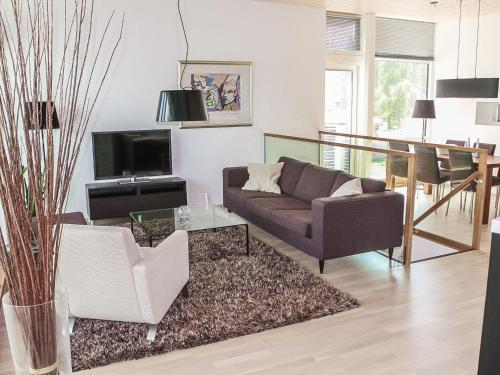 a living room with a couch and a table at Holiday Home Villa marina by Interhome in Padasjoki