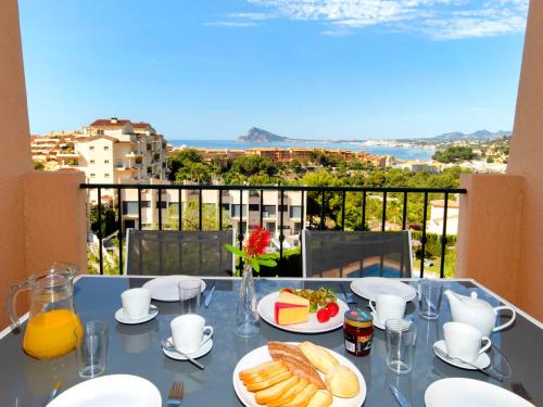 a table with plates of food on top of a balcony at Apartment Residencial Jazmines by Interhome in Calpe