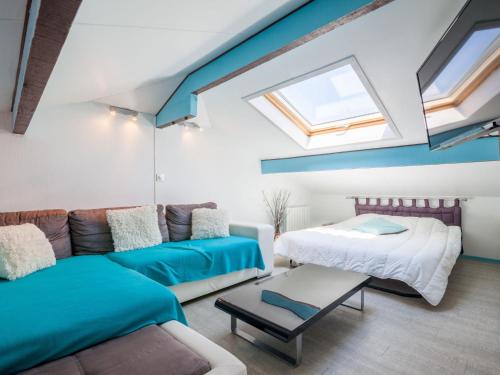 a living room with two beds and a couch at Apartment Maison de l'océan-6 by Interhome in Capbreton