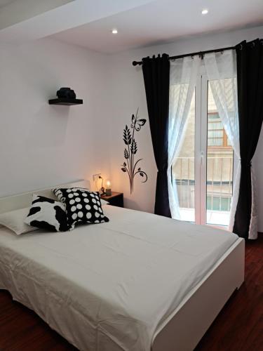 a bedroom with a large bed and a window at Ca la Maria in La Seu d'Urgell