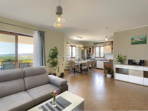 a living room with a couch and a kitchen at Holiday Home Montebello by Interhome in Motovun