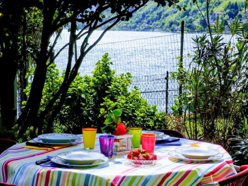 a table with plates and bowls of fruit on it at Apartment Bruna by Interhome in Gera Lario