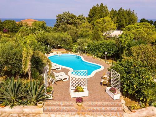 an image of a swimming pool in a garden at Villa La Vela by Interhome in Scopello