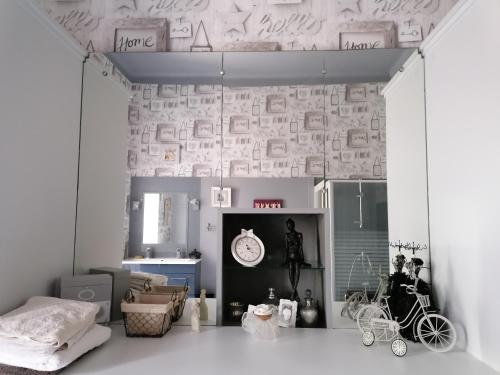 Cette chambre comprend un lit et une horloge murale. dans l'établissement Domaine des Anges, à Trélissac