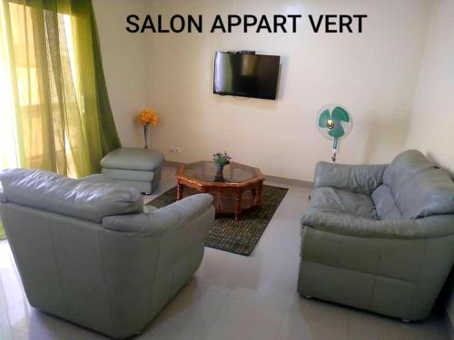 a living room with two couches and a tv at Appartement Beau Séjour 1 in Dakar