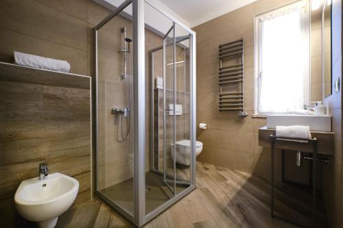 a bathroom with a shower and a sink and a toilet at Villaggio Turistico Lugana Marina in Sirmione