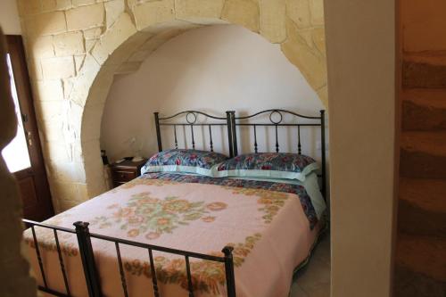 Giường trong phòng chung tại Masseria Cricelli