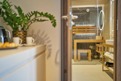 a kitchen with a window and a table with a plant at Five Seasons Szklarska Poręba in Szklarska Poręba