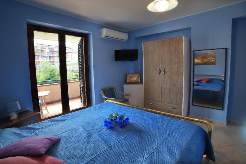 a blue bedroom with a bed with blue flowers on it at B&B PRINCESS ROOM in Capo dʼOrlando