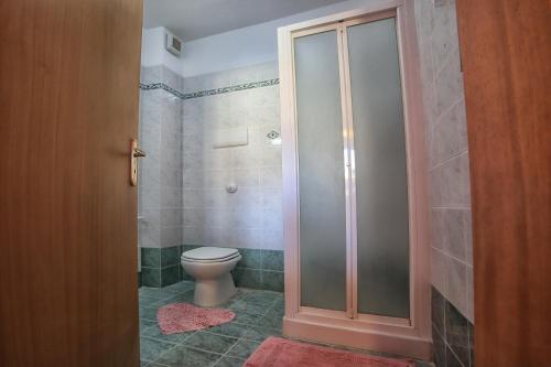 a bathroom with a toilet and a glass shower at B&B PRINCESS ROOM in Capo dʼOrlando