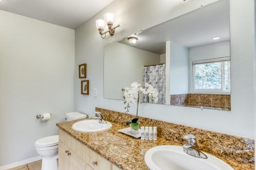 a bathroom with two sinks and a mirror at Waikoloa Neighborhood Retreat in Waikoloa Village