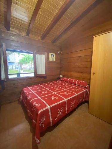 Habitación pequeña con 1 cama en una cabaña en Camping Playa Canelas, en Portonovo