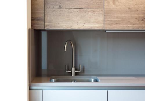 a kitchen with a sink and a wooden cabinet at The New Town Idyll @ Dublin Street in Edinburgh