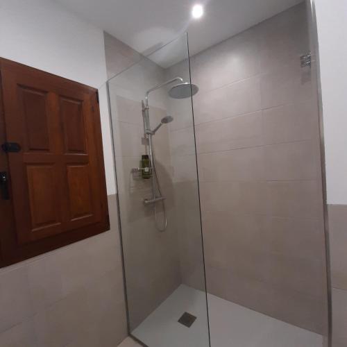 a bathroom with a shower with a glass door at Casa Fénix in Altea