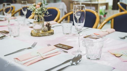a table with pink napkins and wine glasses on it at Penzion Florian in Moldava