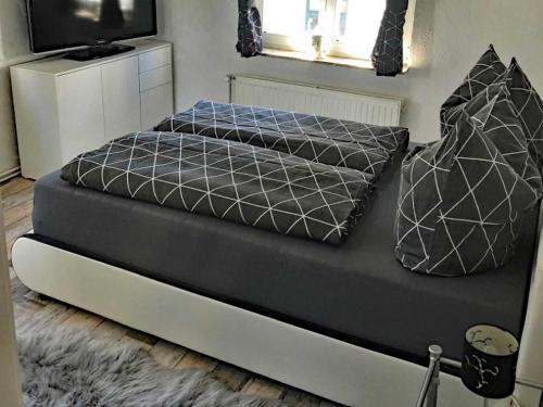 a bed with two pillows on top of it at City Apartment in Waren Müritz in Waren