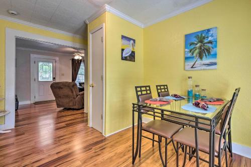 a dining room with yellow walls and a table with chairs at Cozy Gulfport Home Walk to Beach, Marina and Casino in Gulfport
