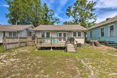 a house with a wooden fence and a yard at Cozy Gulfport Home Walk to Beach, Marina and Casino in Gulfport