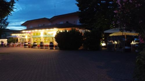 a building lit up at night with lights at Hotel Ristorante alla Campagna in San Giovanni Lupatoto