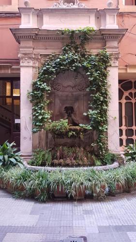 a water fountain in the middle of a building at Matisse Royal in Rome