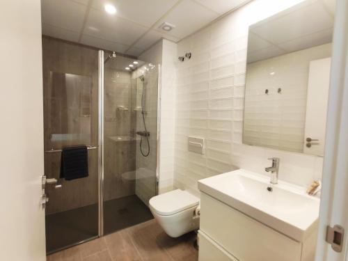 een badkamer met een douche, een toilet en een wastafel bij GLOBAL Apartments & Rooms in Barcelona